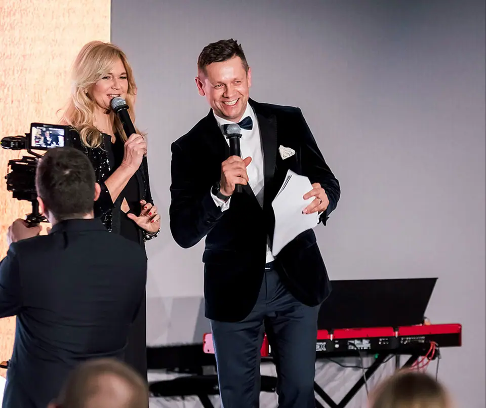 Smiling hosts on the Executive Summit stage — previous editions