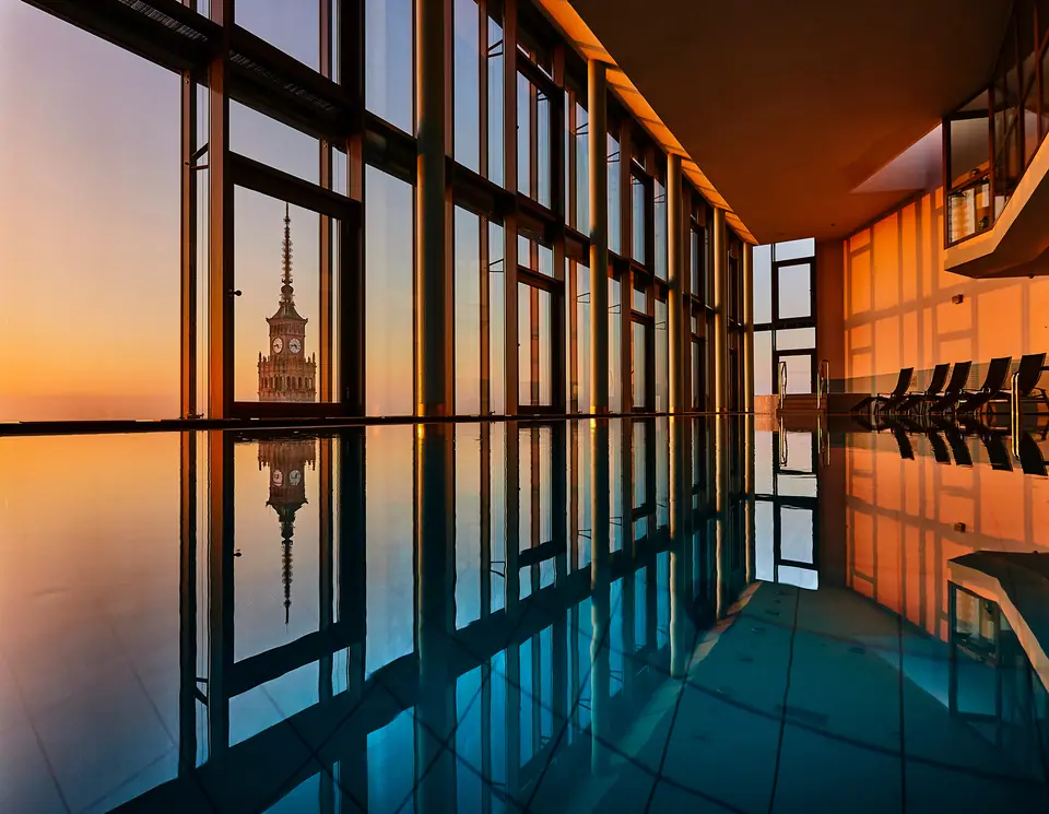 The InterContinental Warsaw pool at sunset, overlooking the city