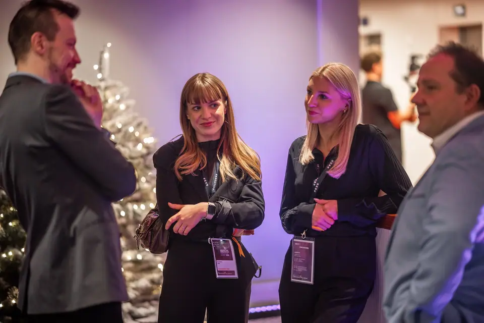 Smiling participants talking in the EXS 2024 lobby