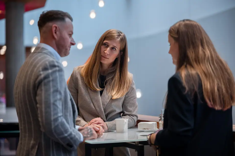 A conversation at a high table in the EXS 2024 lobby