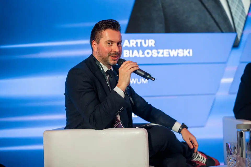 A panellist speaking into the microphone on the EXS 2024 stage