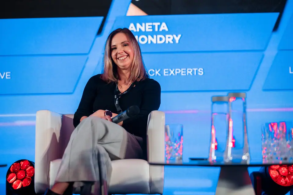A panellist with a broad smile on the EXS 2024 stage