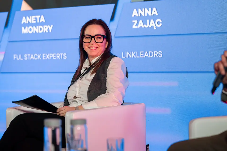 A smiling panellist on the EXS 2024 stage