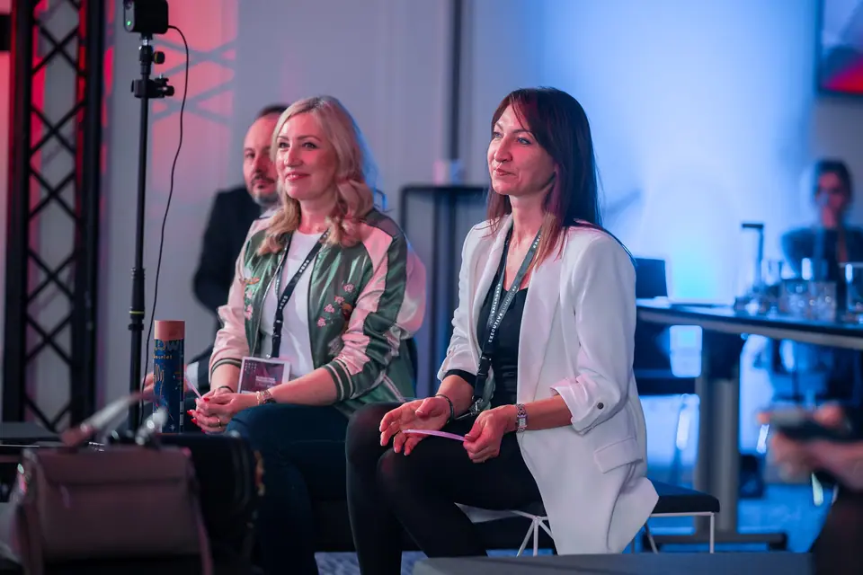 Smiling participants in the front row of the EXS 2024 hall