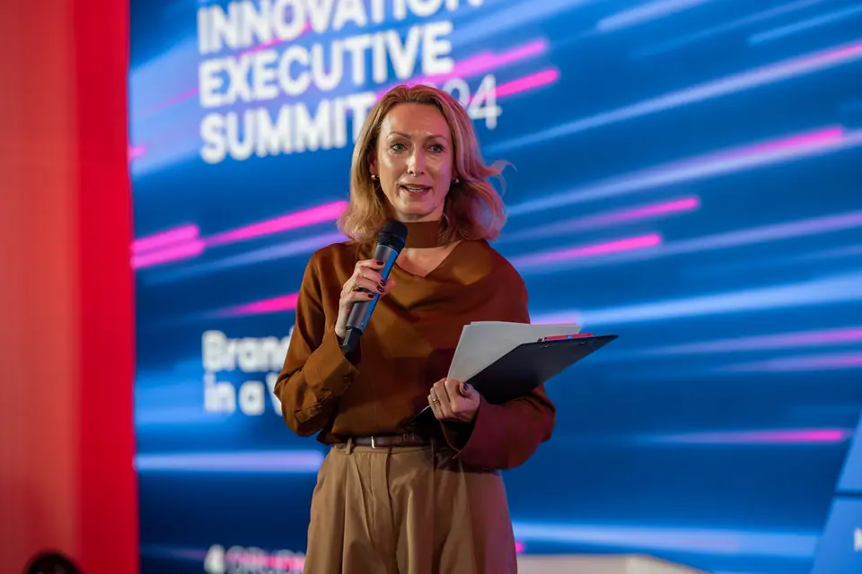 Speaking with a microphone and notes on the EXS 2024 stage